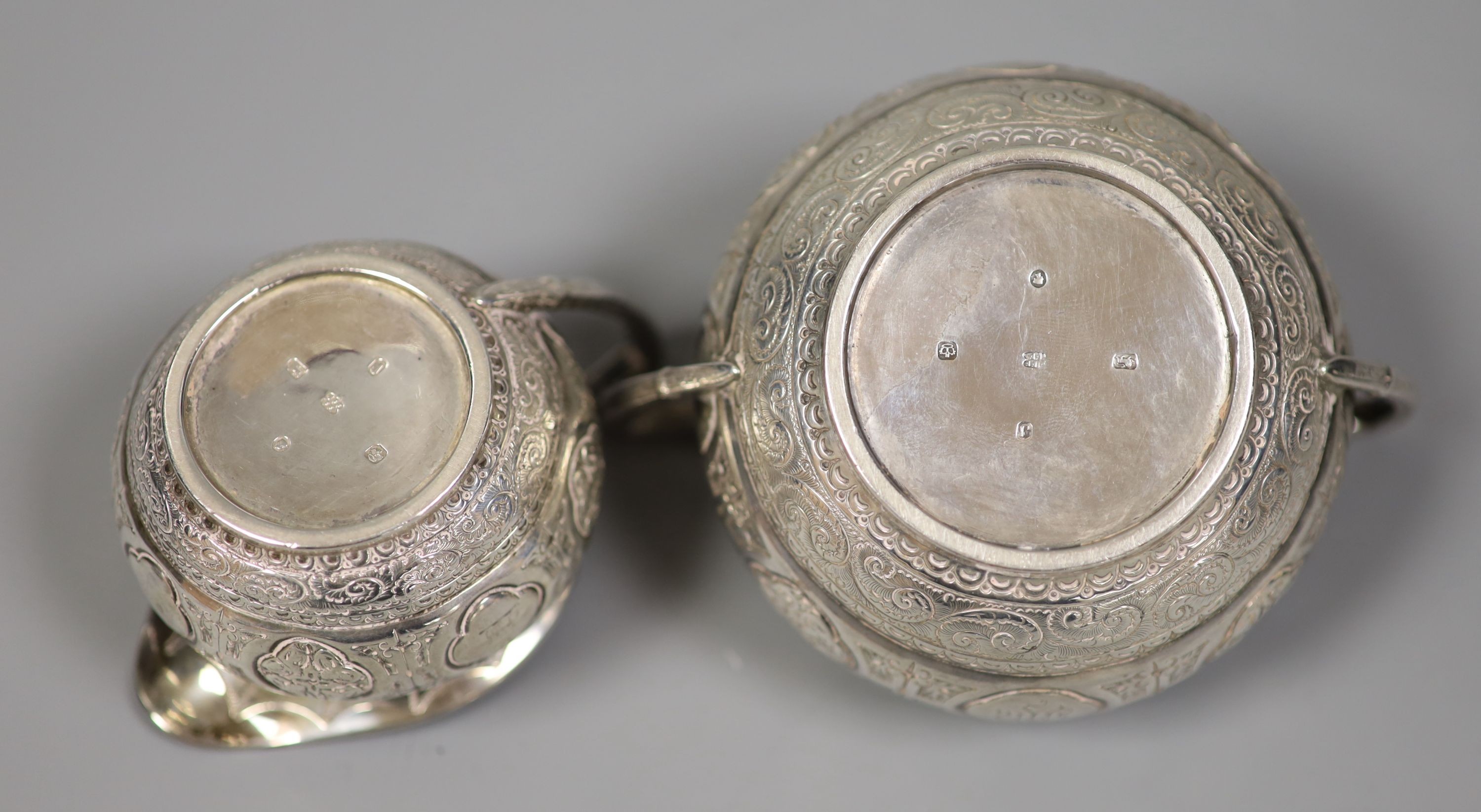 A Victorian engraved silver bachelors cream jug and sugar bowl and pair of matching sugar tongs, Fenton Brothers, Sheffield, 1876, 7.5oz.